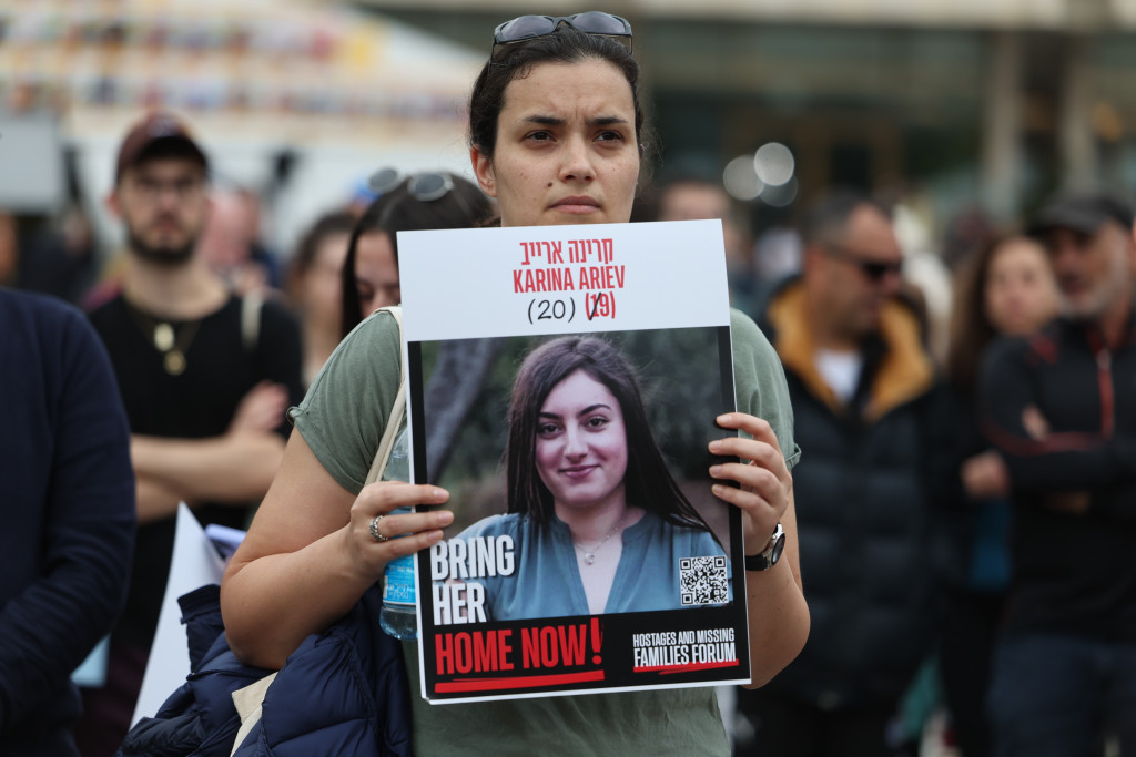 Een vrouw houdt een foto vast van één van de gegijzelden.